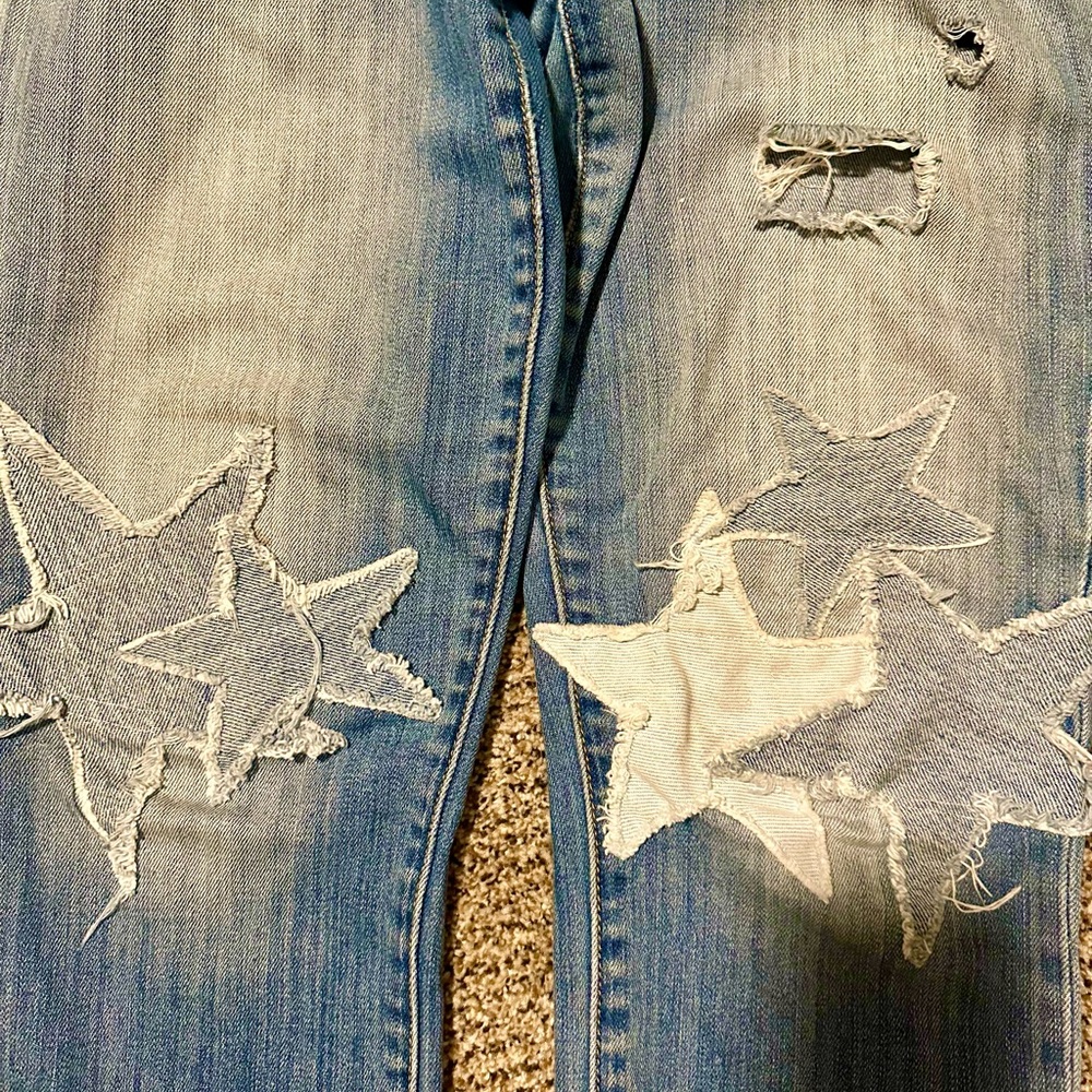 Women’s size 8 AE jeans. Distressed, homemade repair with stars.